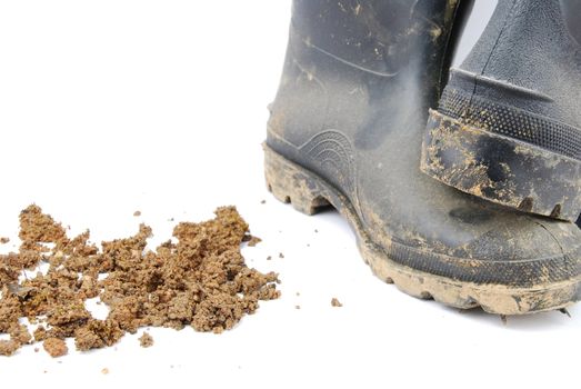 pair of muddy farmer boots isolated on a white background