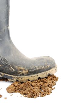one muddy farmer boot isolated on a white background