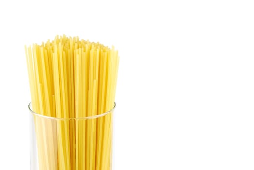 italian long spaghetti pasta on a glass container isolated on white background