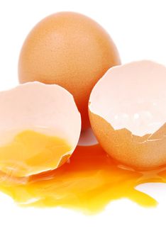 broken egg with the yolk and white oozing out isolated on white background