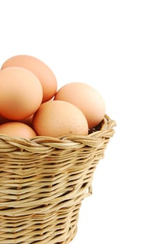 close-up of eggs in a traditional wicker basket isolated on white background