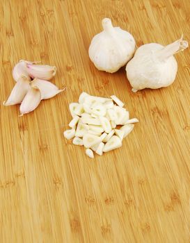 all, chopped and slices of garlic on a wooden cutting board