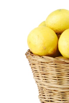 close-up of lemons in a traditional wicker basket isolated on white background