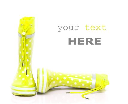 Yellow rubber boots for kids isolated on white background (with space for text)
