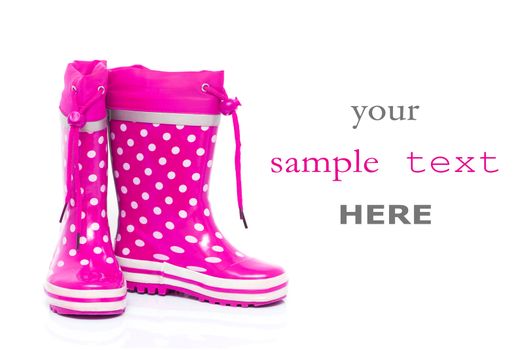 Pink rubber boots for kids isolated on white background (with space for text)