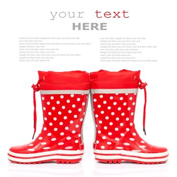 Red rubber boots for kids isolated on white background (with sample text)