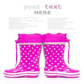 Pink rubber boots for kids isolated on white background (with sample text)