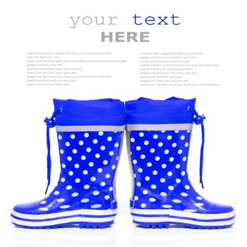 Blue rubber boots for kids isolated on white background (with sample text)