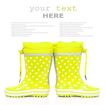 Yellow rubber boots for kids isolated on white background (with sample text)