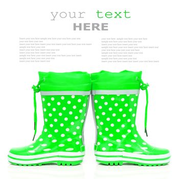 Green rubber boots for kids isolated on white background (with sample text)