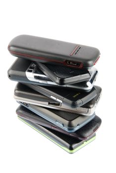 pile of several mobile phones isolated on white background