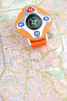 orange compass on a city map (travel/orientaion concept)