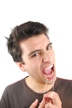 young man flossing his teeth isolated on white background