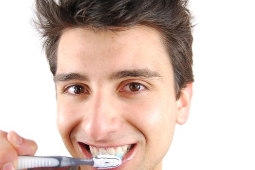 cheerful young man is washing teeth over white background
