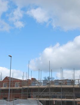 residential brick building under construction (blue sky background)