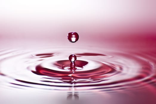 Red water environmental abstract background - red water drop splashing in clear clean water