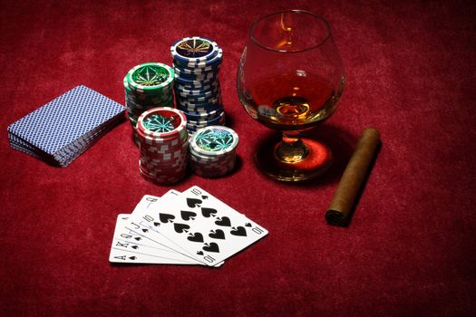 Playing poker concept. Stack of chips, cards, cigar and glass