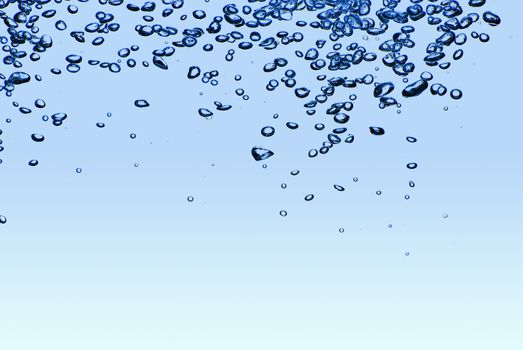 Isolated blue water splashing with bubbles and water drops - abstract blue background environmental theme