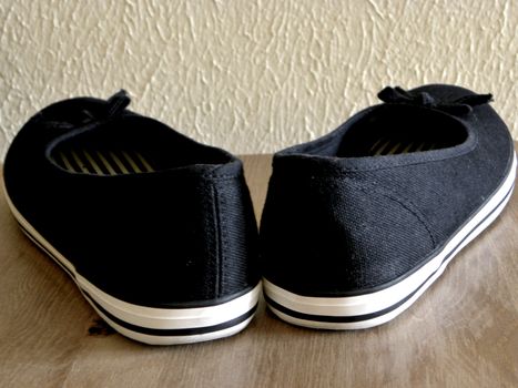 Black and white plimsoll with bows.