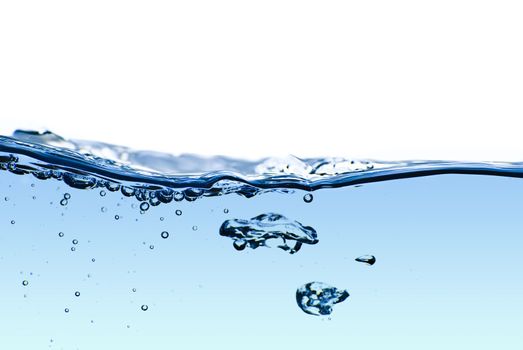 Isolated blue water splashing with bubbles and water drops - abstract blue background environmental theme