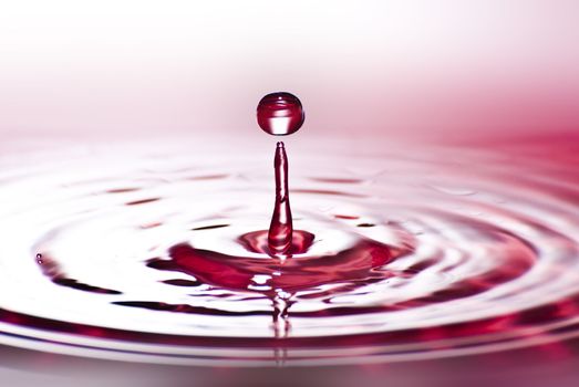 Red water environmental abstract background - red water drop splashing in clear clean water