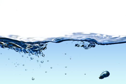 Isolated blue water splashing with bubbles and water drops - abstract blue background environmental theme