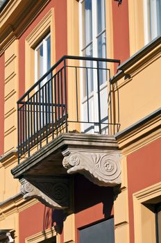 Detail of balcony in colorful house facade.
