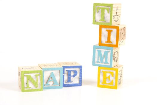 Colorful childrens blocks spell the words nap time.