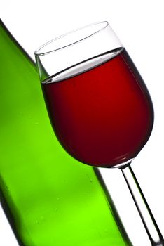 Bottle and glass of red wine isolated on white background