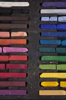 A line of colorful chalk in it's case.