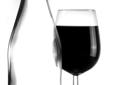 Bottle and glass of red wine isolated on white background - abstract black and white colors
