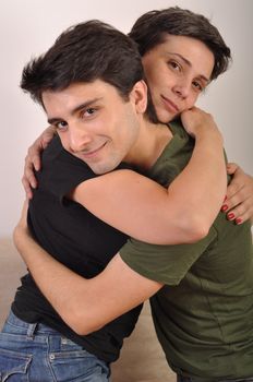 loving hug between sister and brother on the couch