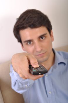 smiling attractive young man watching televison