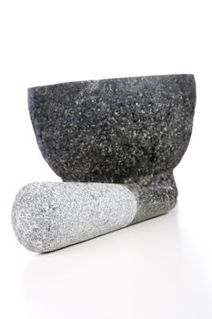 Granite mortar and pestle isolated on white background.
