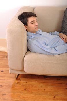 attractive young man sleeping on the couch