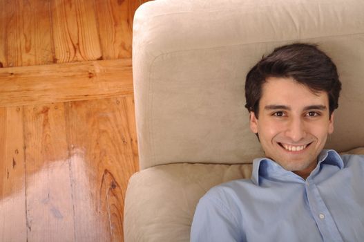 attractive young man lying and relaxing on the couch