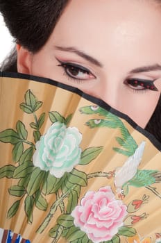 Portrait of the girl of the Asian appearance with a make-up under the geisha on a white background