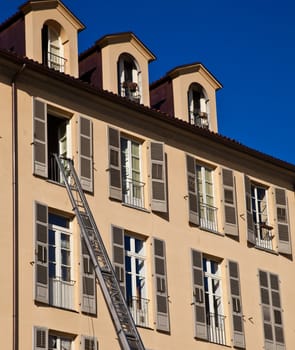Ladder used to move furniture with elegant palace in background