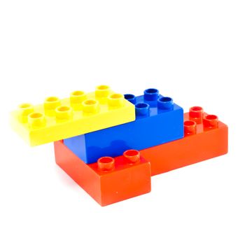 Plastic building blocks on white background. Bright colors.