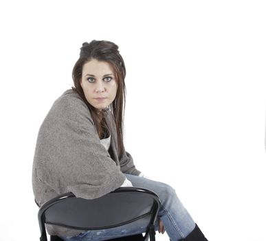 Young woman in studio with metalic chair, looking at the camera