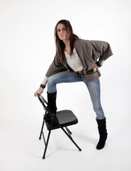 Young woman in studio with metalic chair, looking at the camera