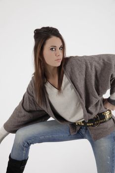 Young woman in studio regarding at the camera
in blue jean