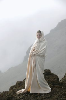 The girl shrouded in a cloud, it is high in mountains, early in the morning.