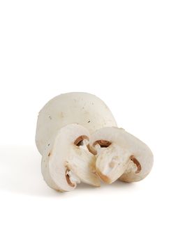 Fresh champignons cut on halves on white background