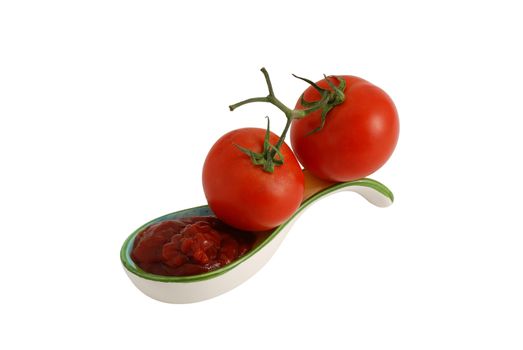 Two fresh tomato and ketchup in decorative ceramic spoon isolated on white background