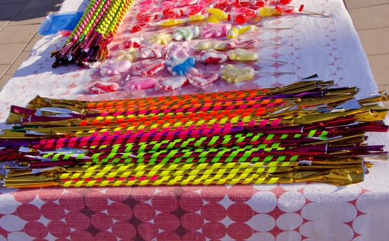 Long and delicious candies are packed in lovely colored paper. Summer street fair.