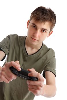 A teenage boy holding a wireless game controller and concentrating on the game.