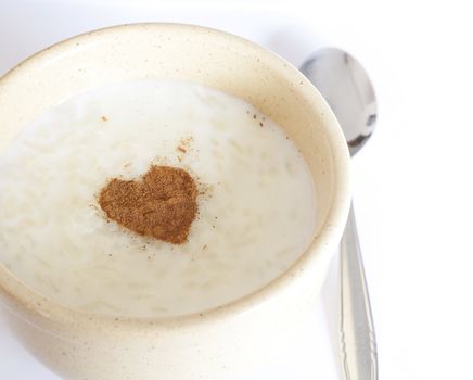 Brown bowl of rice pudding and cinnamon heart