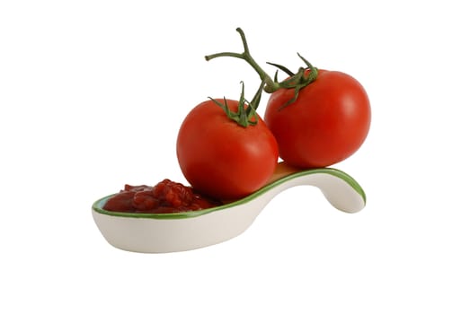 Two fresh tomatoes and ketchup in decorative ceramic spoon isolated on white background