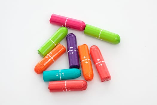 Colourful wrapped tampons on a white background.